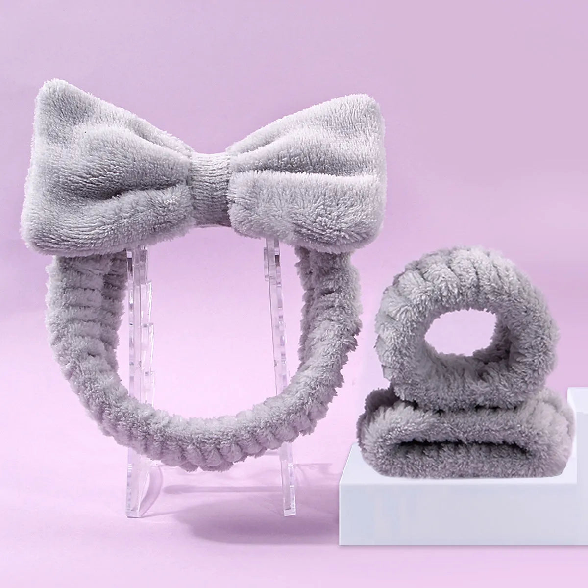 Facial brush set with coral fleece hair band and four nylon brush heads in purple grey white pink colours