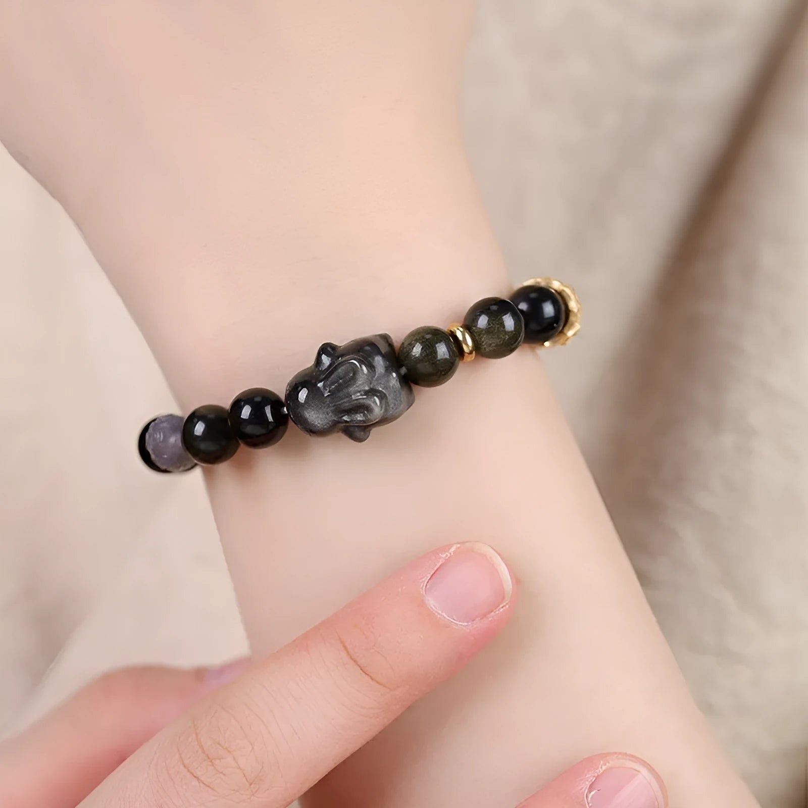 Handmade lying rabbit obsidian bracelet with Jin Yaoshi and brass beads, available in 8mm and 10mm sizes.