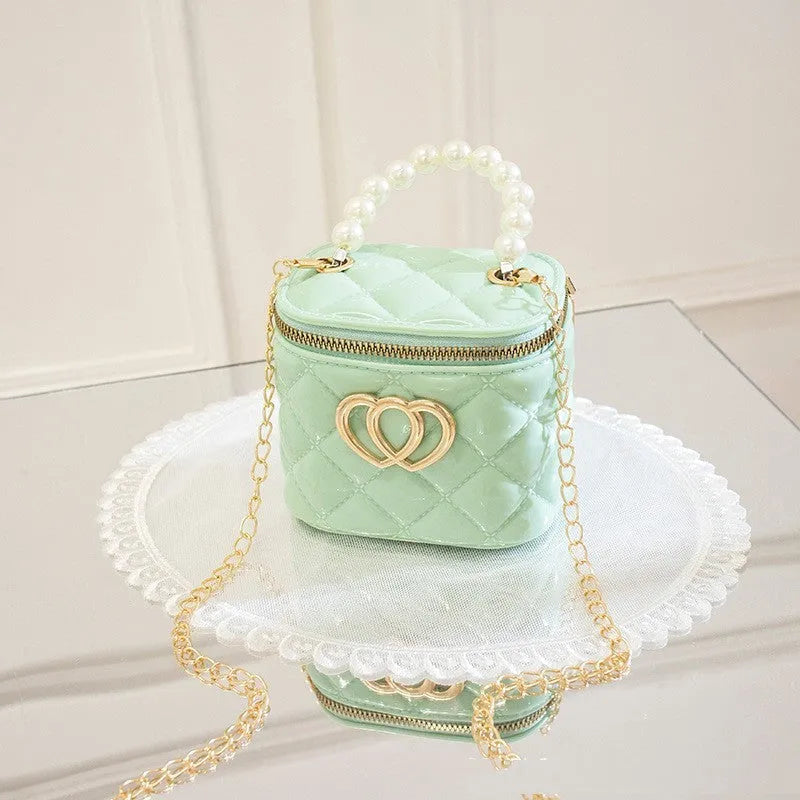 White PVC bucket-shaped cosmetic bag with a heart pattern, shown open.