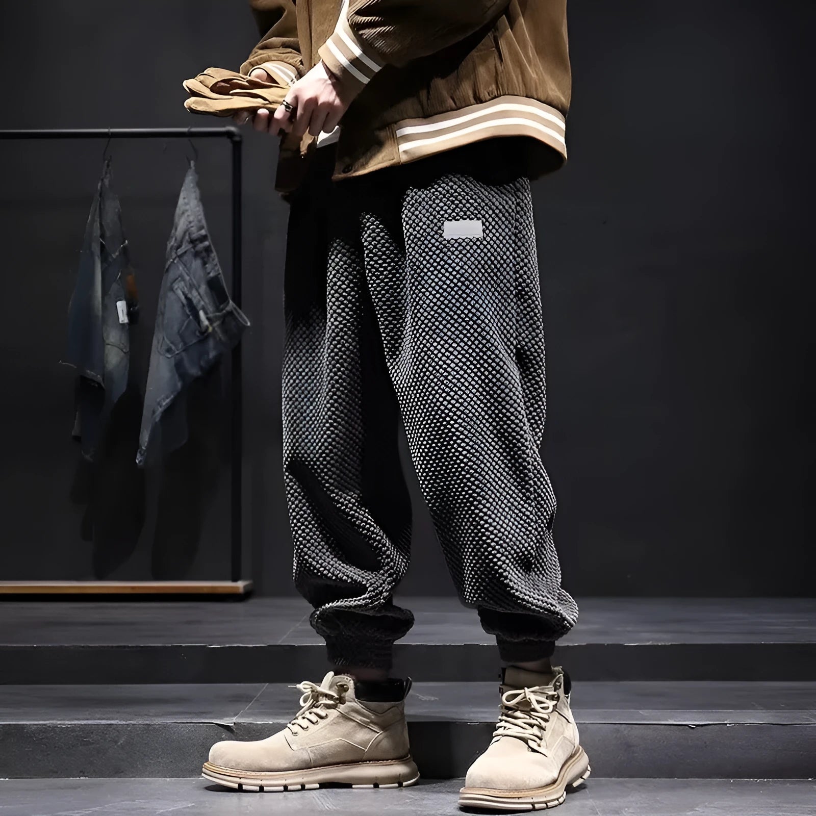 Men's grey straight leg sweatpants with ankle strap detail on a plain background.