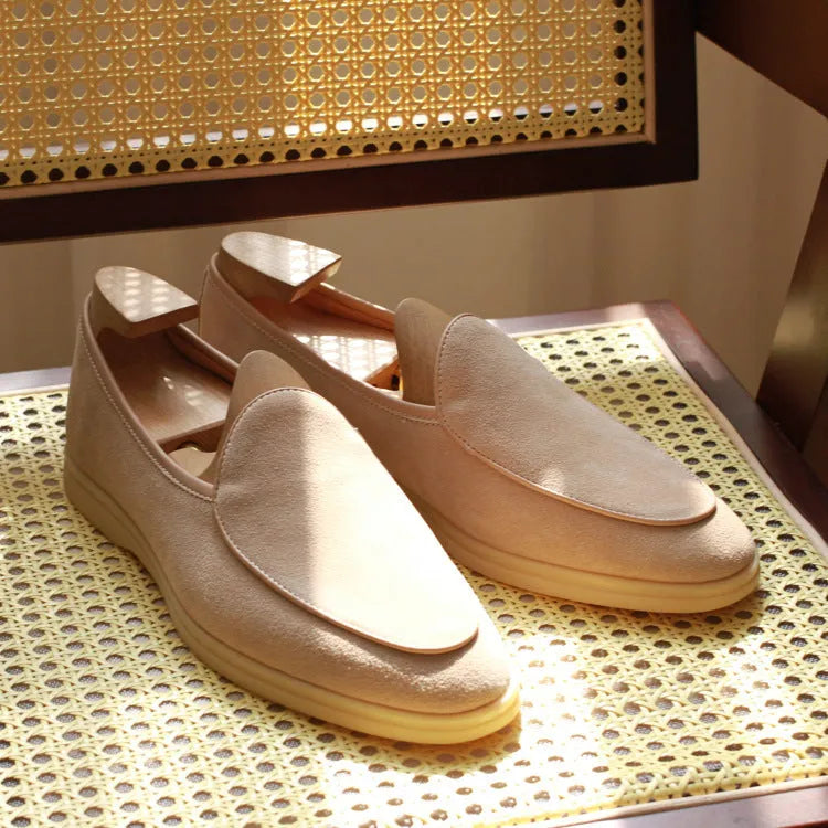 Men's brown genuine leather slip-on loafers on a white background.