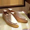 Men's brown genuine leather slip-on loafers on a white background.