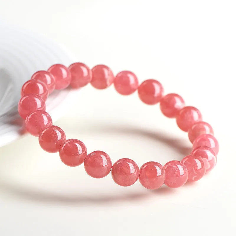 Women's geometric crystal bracelet with a longevity lock clasp in natural red rhodochrosite stone.