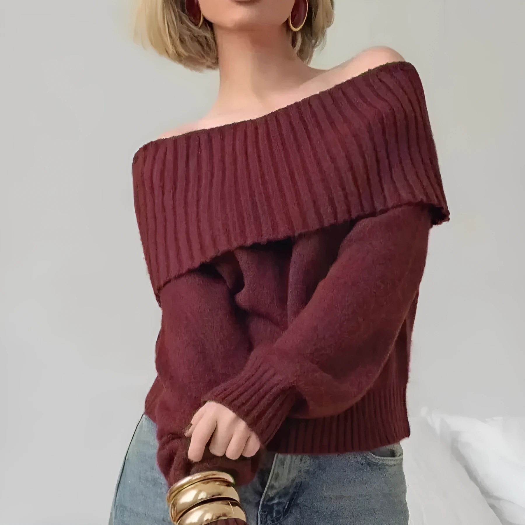 Woman wearing a grey off-the-shoulder sweater with a 3D textured pattern.