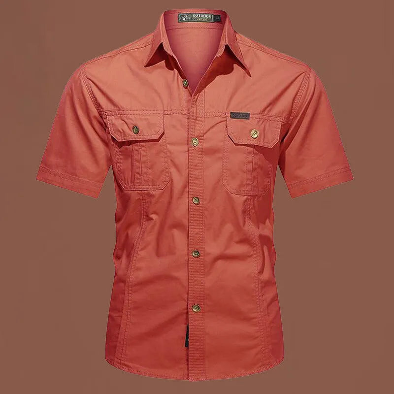 Men's army green cotton work shirt with short sleeves and non-iron finish on a hanger.