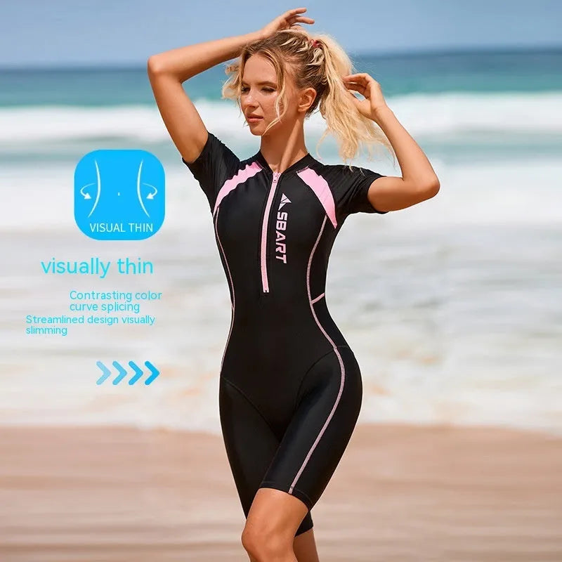 Women's solid colour surf one-piece swimsuit with short sleeves and built-in chest pad.
