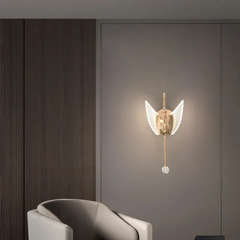 Modern minimalist gold swan-shaped LED wall lamp for bedside lighting.