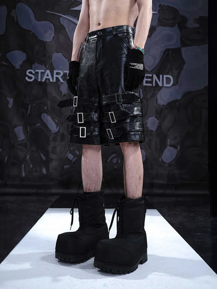 Men's black PU leather casual cropped shorts on a hanger.