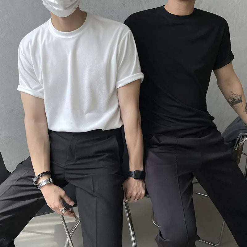 Men's slim fit cotton T-shirt in black solid colour, showing round neck and half sleeves.
