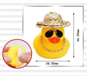 Yellow cartoon duck with straw hat car ornament on dashboard with sunglasses accessory