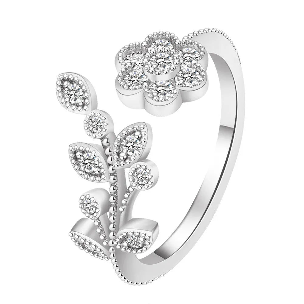Open mouth floral ring with diamond-treated surface showing flower and leaf pattern in copper