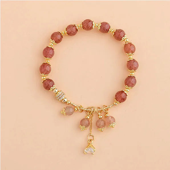 Pink strawberry quartz crystal heart-shaped women's bracelet with pearl accents.