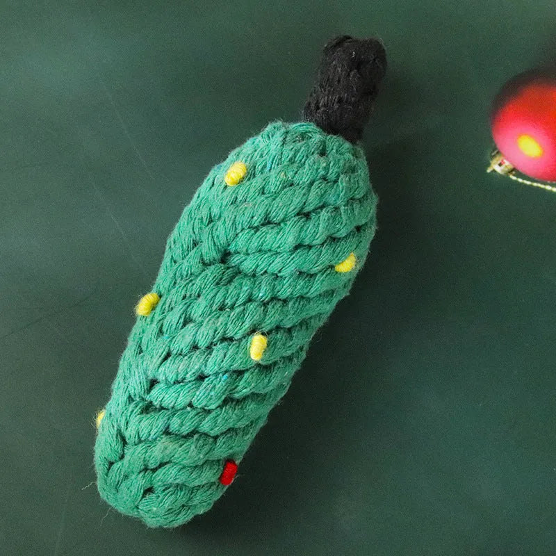 Four Christmas-themed cotton rope dog toys in red and green, including candy cane, bone, crutch, and tree shapes