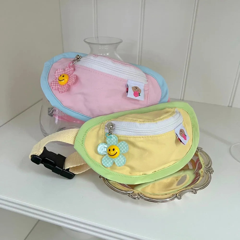 Pink adjustable backpack-style messenger bag carrier for a small dog or cat, showing the poop bag holder.