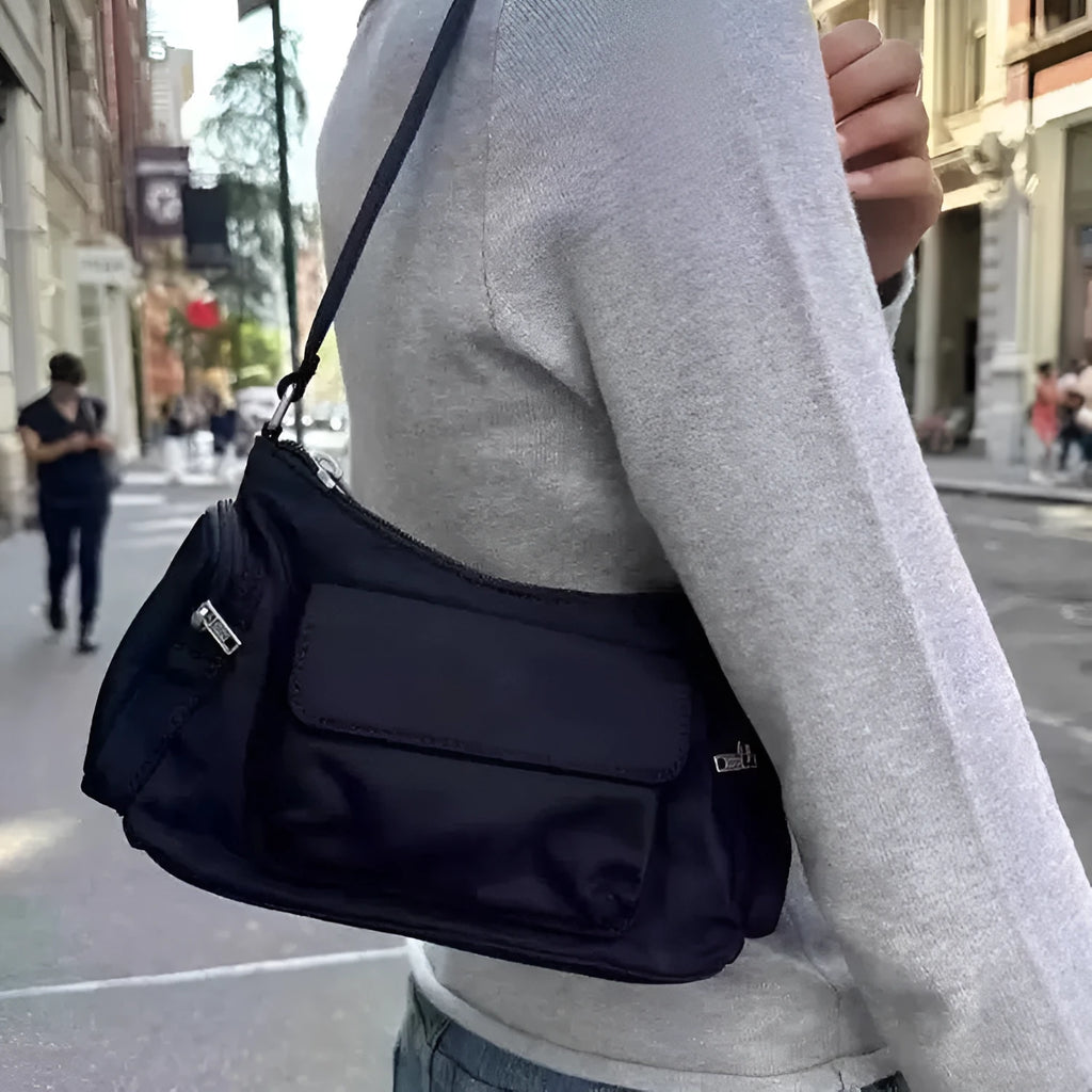 Black PU leather women's shoulder bag with side line detail and double interior pockets.