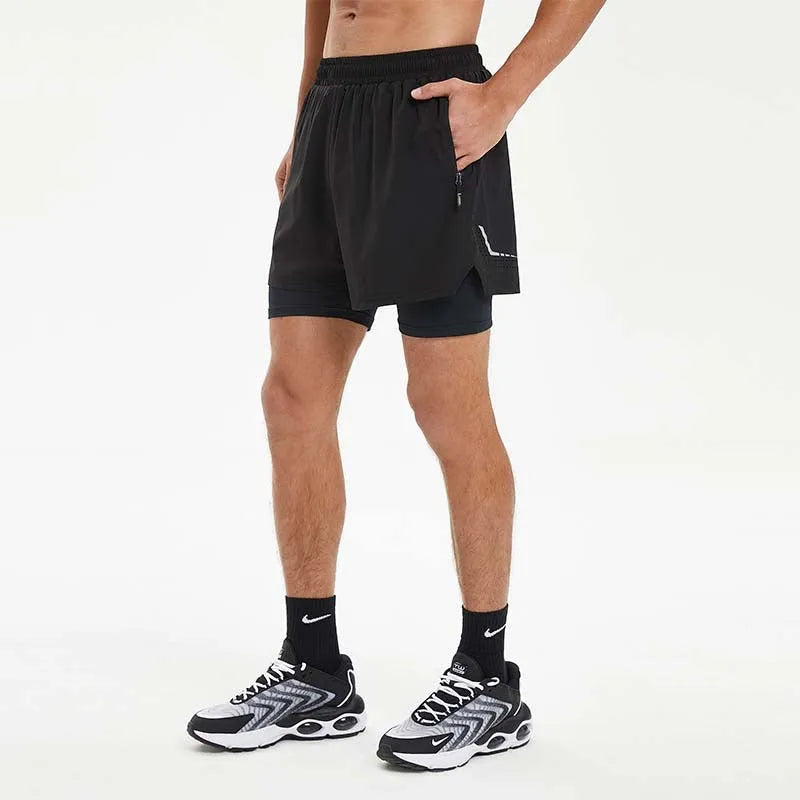 Man wearing black double-layer sports shorts with a spandex liner for running, showing short length and mid waist design.