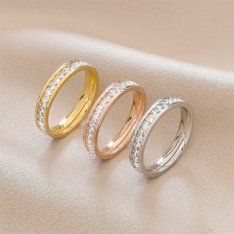Stainless steel geometric star ring with zircon inlay in gold finish on white background