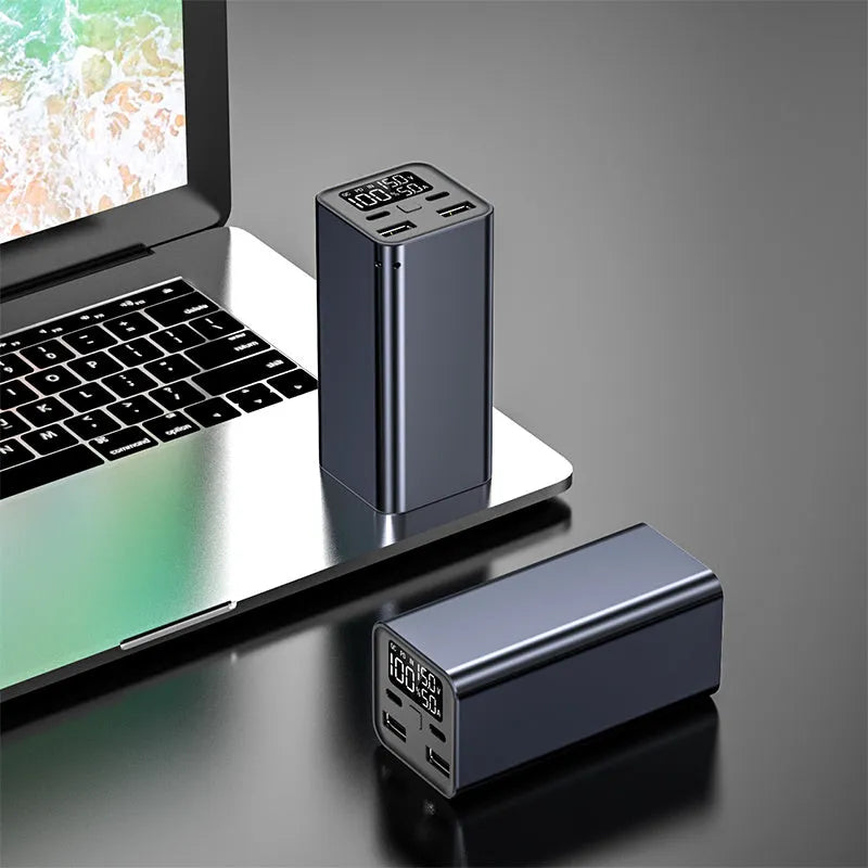 Black 65W metal power bank with 20000mAh capacity for charging laptops and phones.