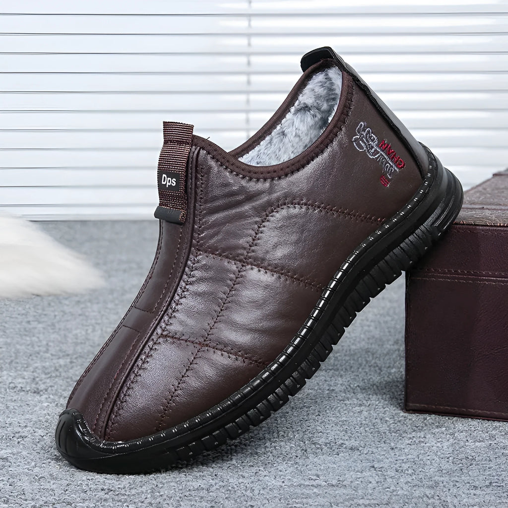 Men's brown winter cotton boots with a buckle closure and a thick, treaded non-slip sole.