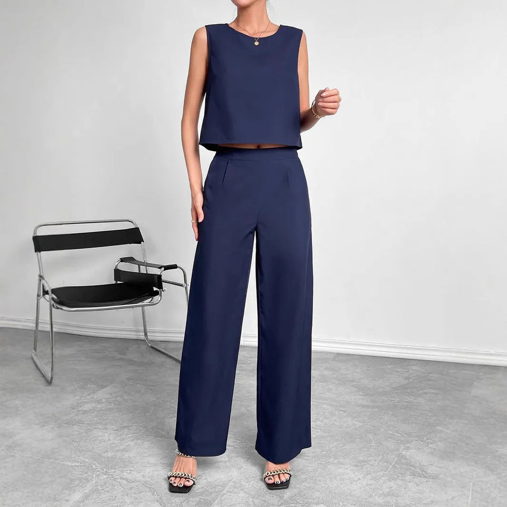 Red women's two-piece set featuring a sleeveless round-neck top and matching wide-leg trousers on a hanger.