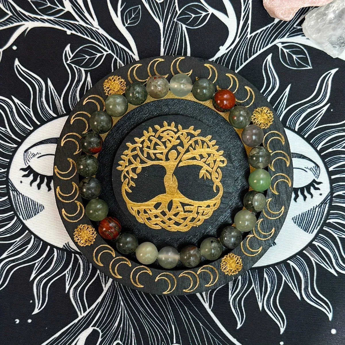 Handmade African Bloodstone beaded bracelet with 8mm transparent glass beads on neutral background