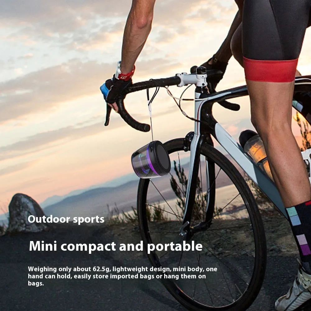 Portable white or black Bluetooth speaker with ambient lighting and magnetic design on a desktop