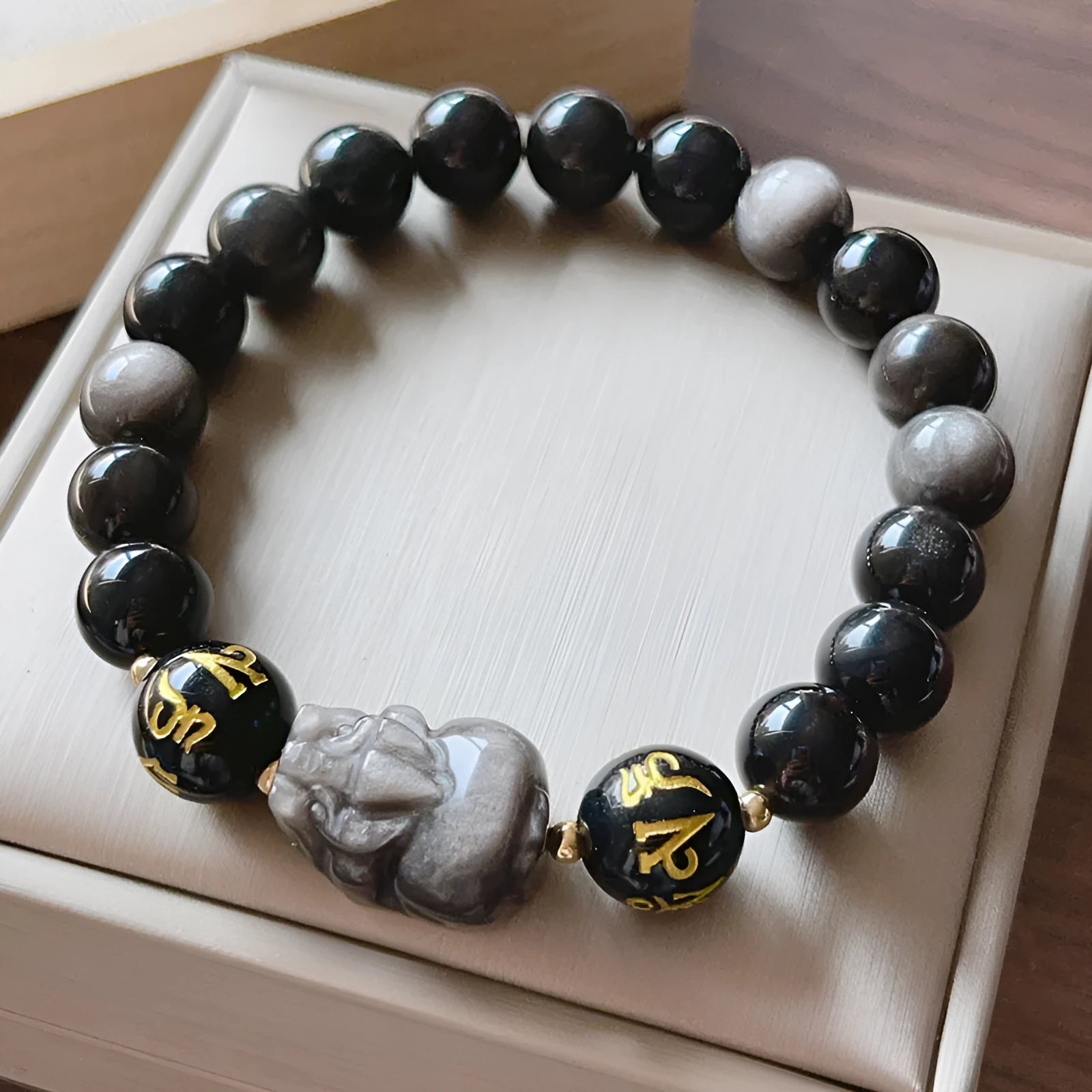 Men's silver stone beaded bracelet with Chinese style and engraved proverbs on a dark background.