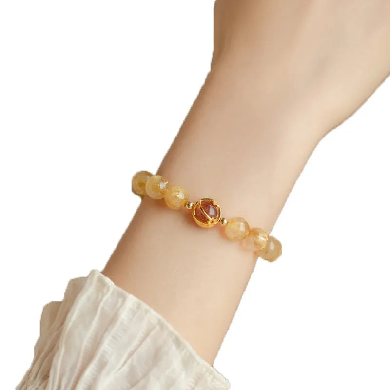 Gold rutilated quartz bracelet with diamond-cut beads in two size options