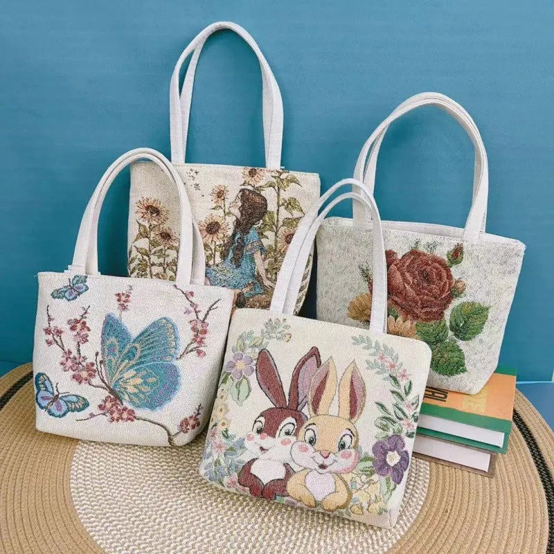 Double-sided gold wire embroidered handheld canvas tote bag in a choice of seven patterns and three sizes.