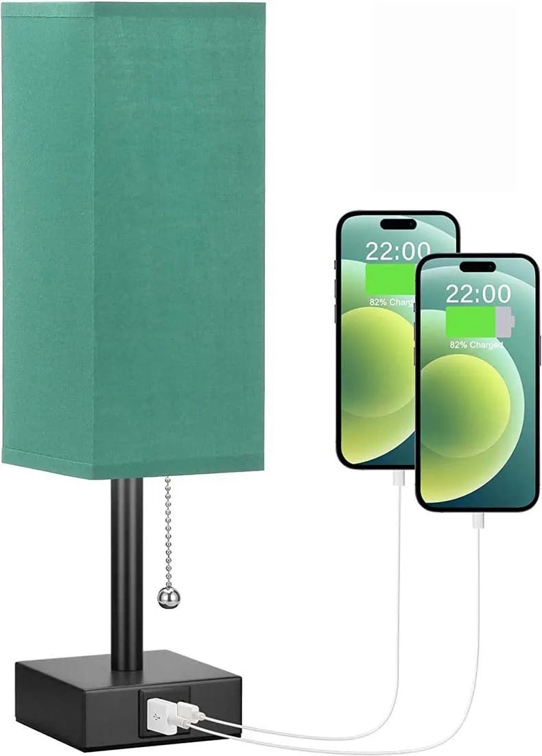 Small bedside table lamp with beige fabric shade and black base on a nightstand