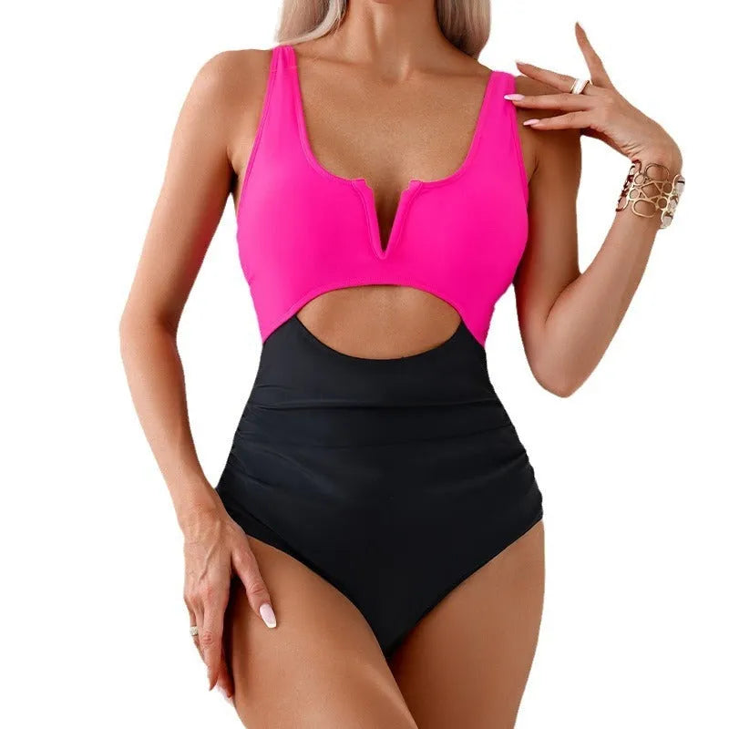Women's green and black colour-block one-piece nylon swimsuit on a size mannequin.