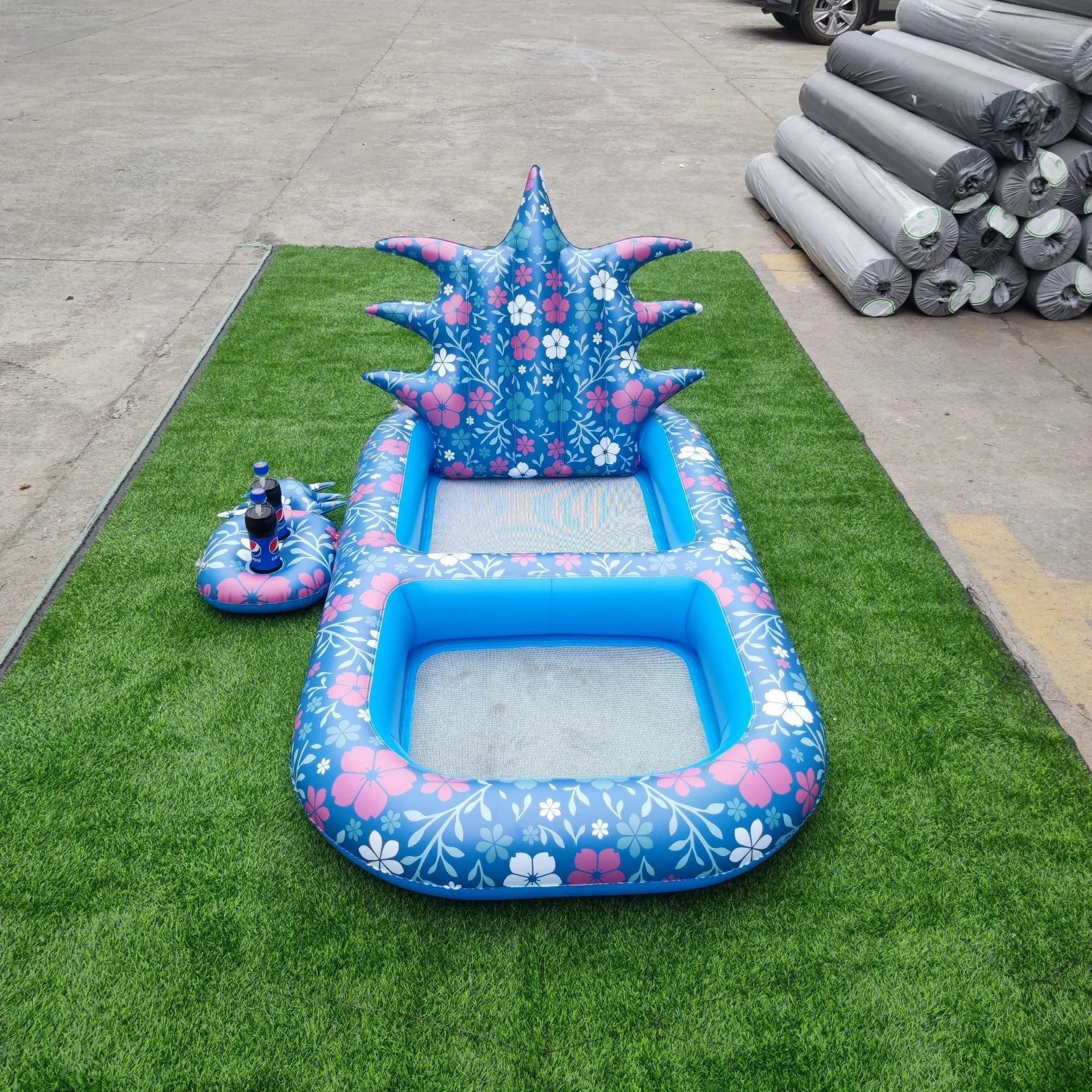 Inflatable pineapple pool lounger with cup holder floating on water in yellow colour