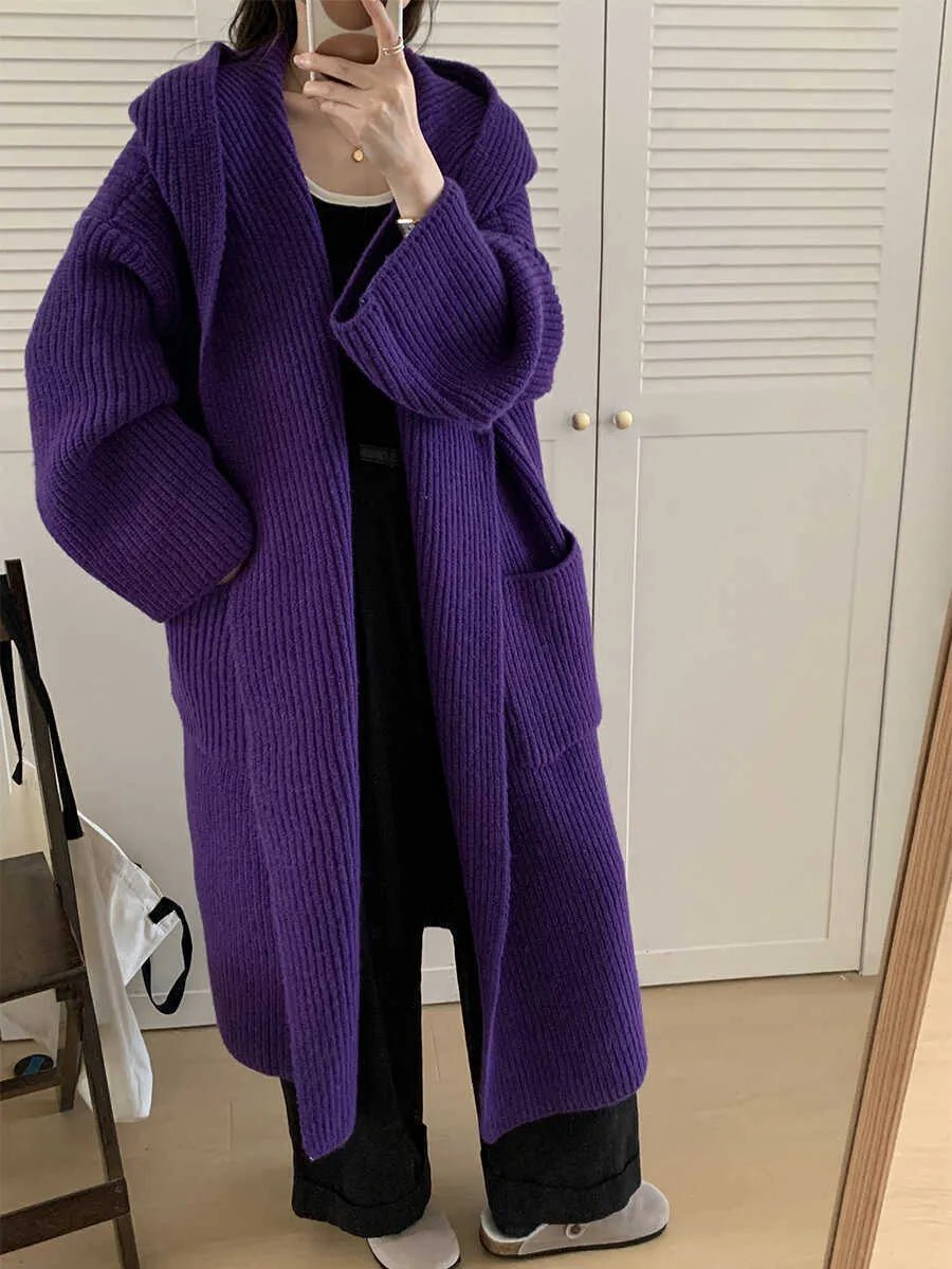 Loose grey hooded cardigan coat with raglan sleeves shown on a hanger.