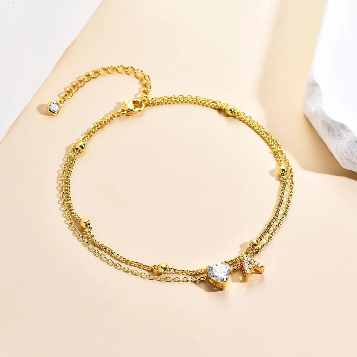 Copper initial anklet with zircon letter and double ring design, available in bead zircon or claw chain zircon