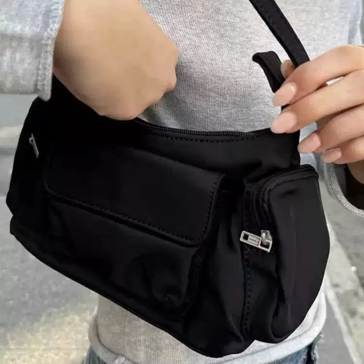 Black PU leather women's shoulder bag with side line detail and double interior pockets.