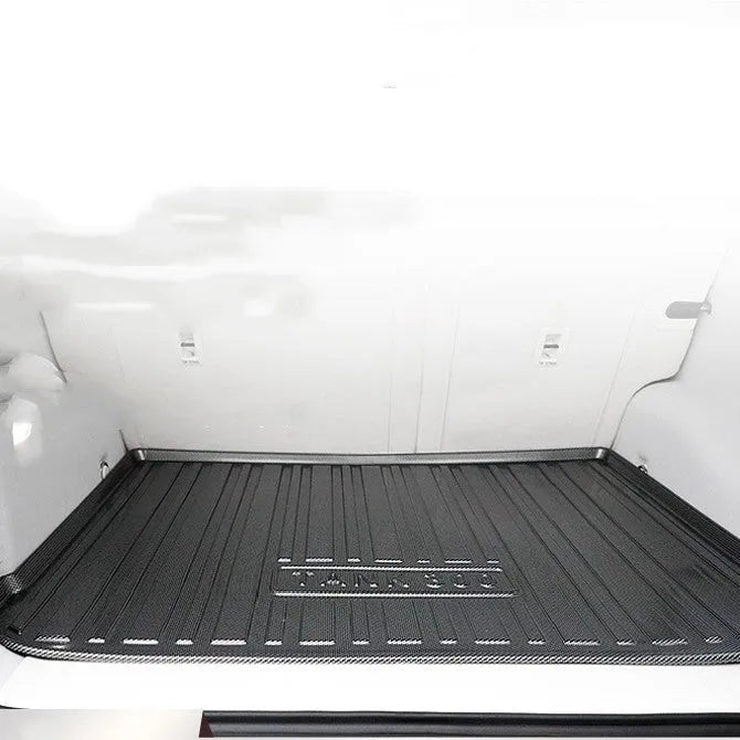 Black TPE car boot liner with carbon fibre texture pattern for specific vehicle models.