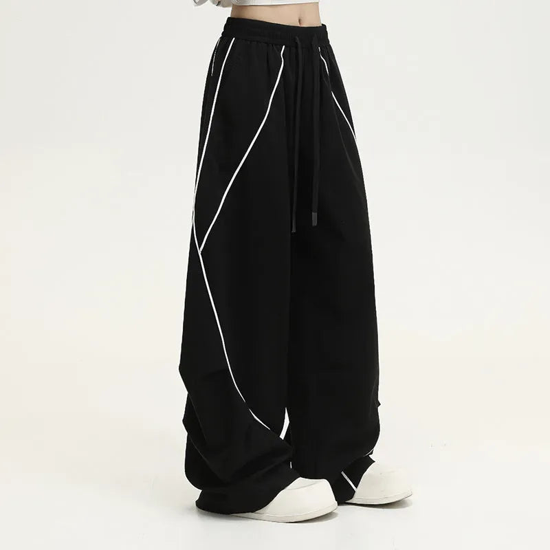 Black pleated wide-leg hip hop trousers with stripes, loose fit for sports.