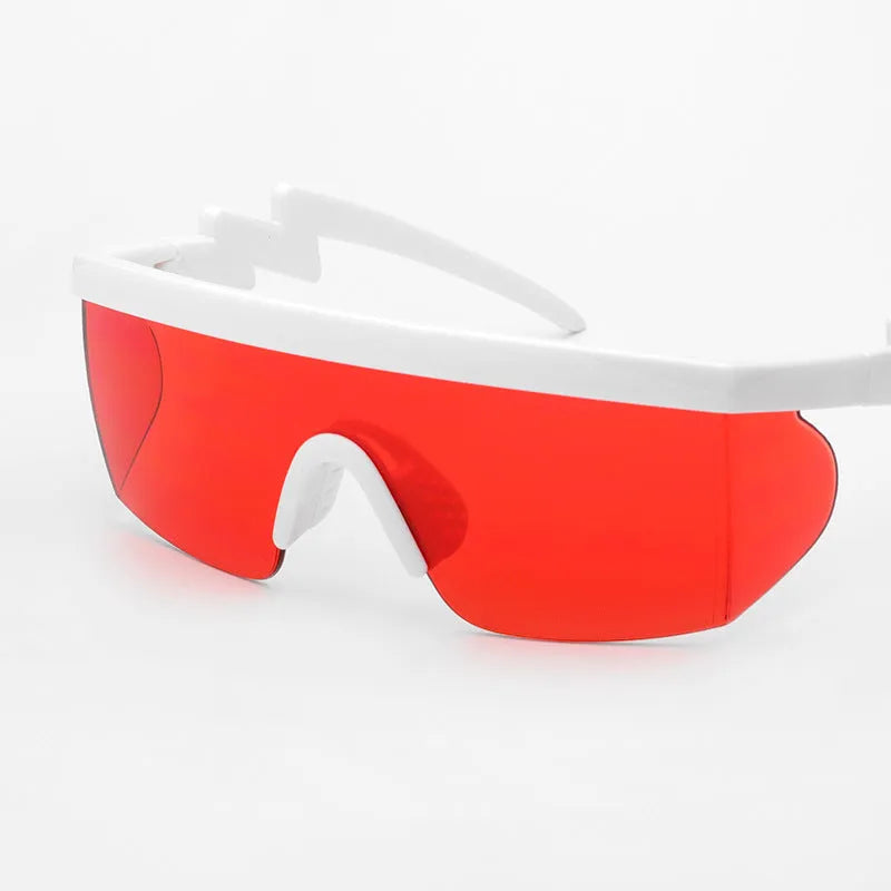 Sports sunglasses with colourful lens film, black half-frame, and curved foot piece for active outdoor use