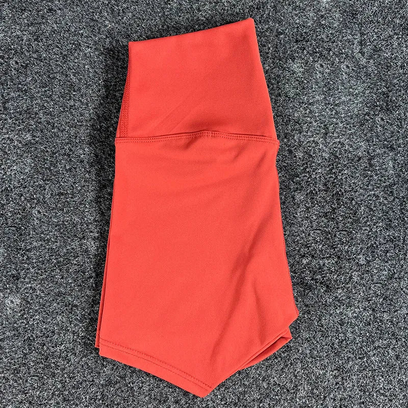 High-waisted women's yoga shorts in nylon fabric on a neutral background.