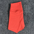 High-waisted women's yoga shorts in nylon fabric on a neutral background.