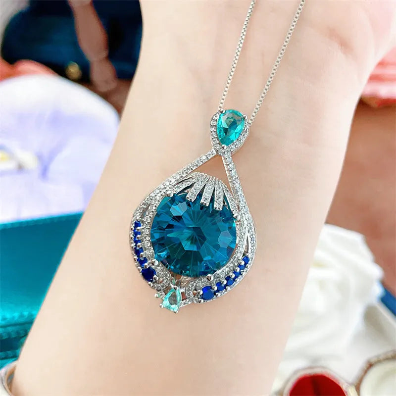 Geometric pendant necklace with blue fireworks cut gemstones on water wave chain