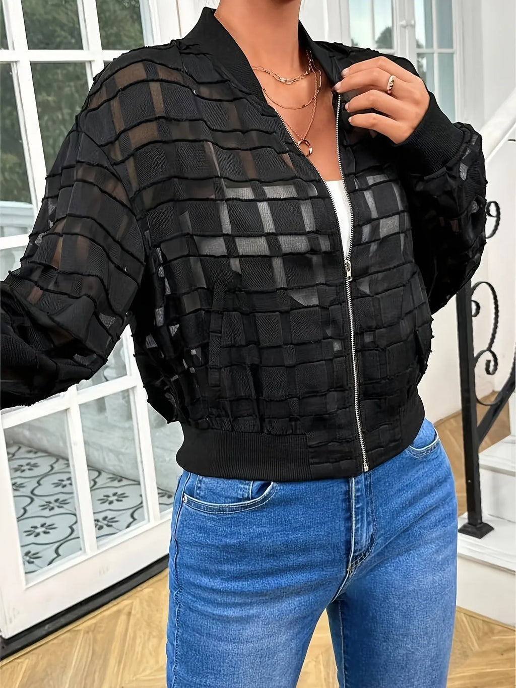 Black women's casual jacket with geometric pattern on semi-transparent fabric and threaded zipper.