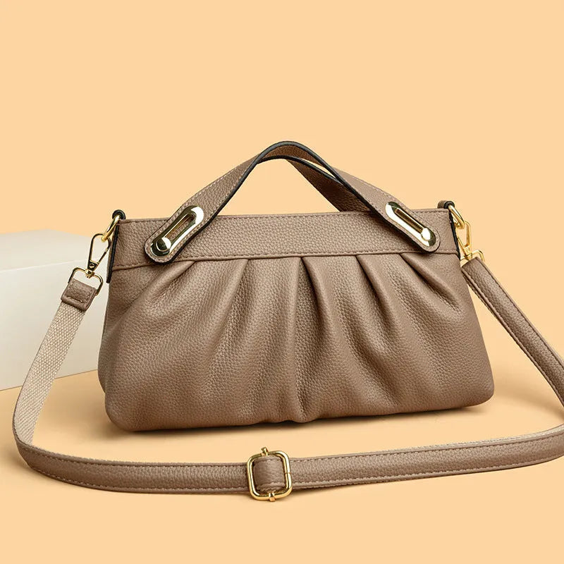 Genuine leather crossbody bag with pleated shoulder strap, horizontal square shape, available in six colours including black, khaki, green, beige, blue, red