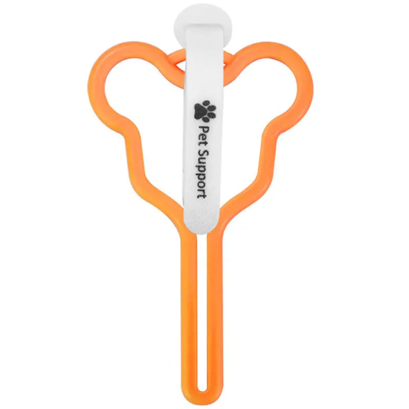 A hands-free dog poop bag holder with a fixed clip and adjustable black Velcro strap, shown attached to a dog lead.