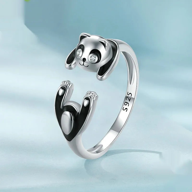 Adjustable sterling silver panda ring with white gold plating on a finger