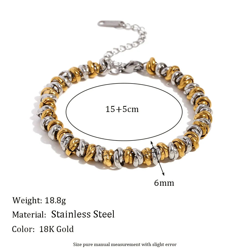 Gold tone electroplated stainless steel jewellery set with geometric shapes including earrings, bracelet and necklace