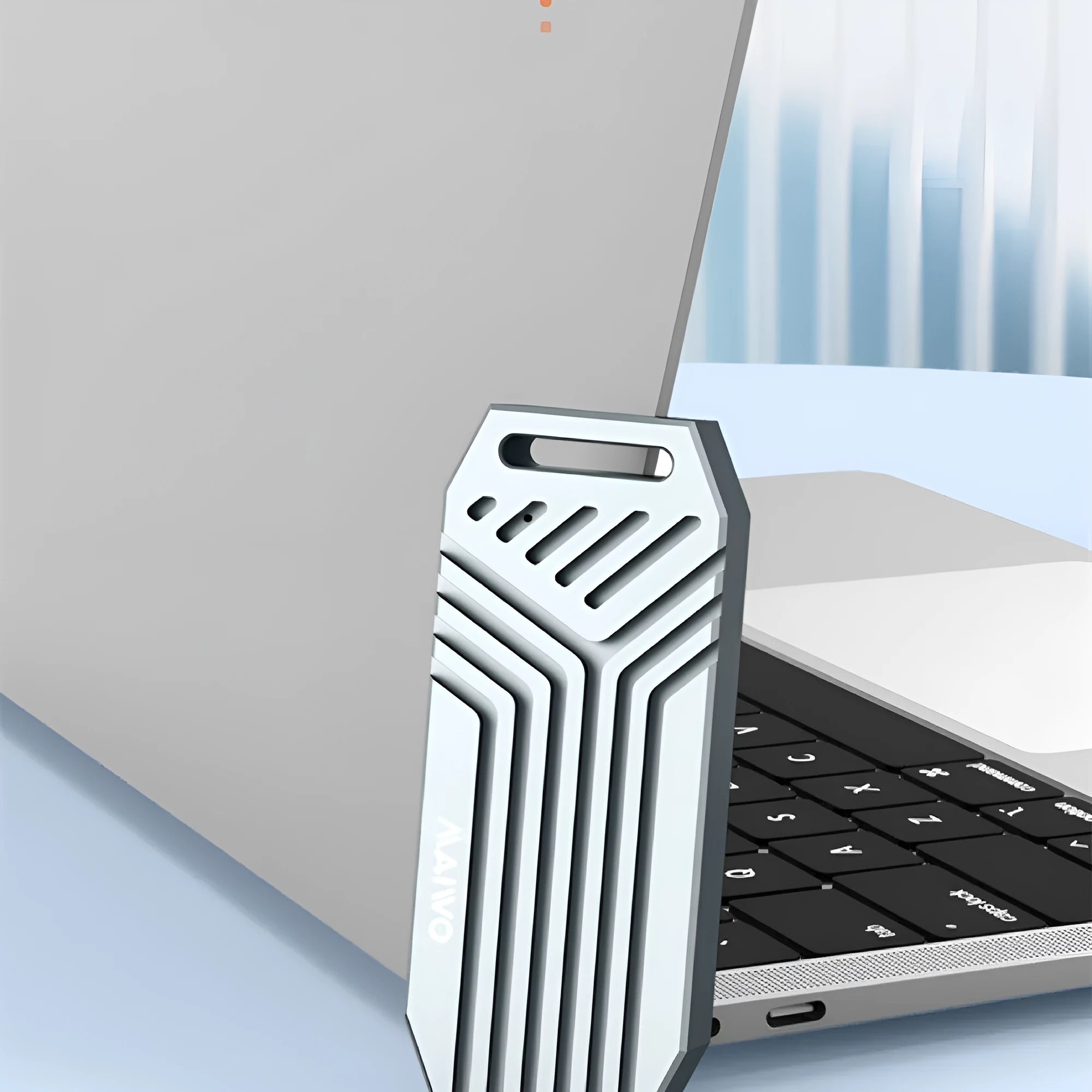 Silver and grey aluminium Thunderbolt 4 external SSD enclosure for M.2 drives, shown next to a cooling fan accessory.