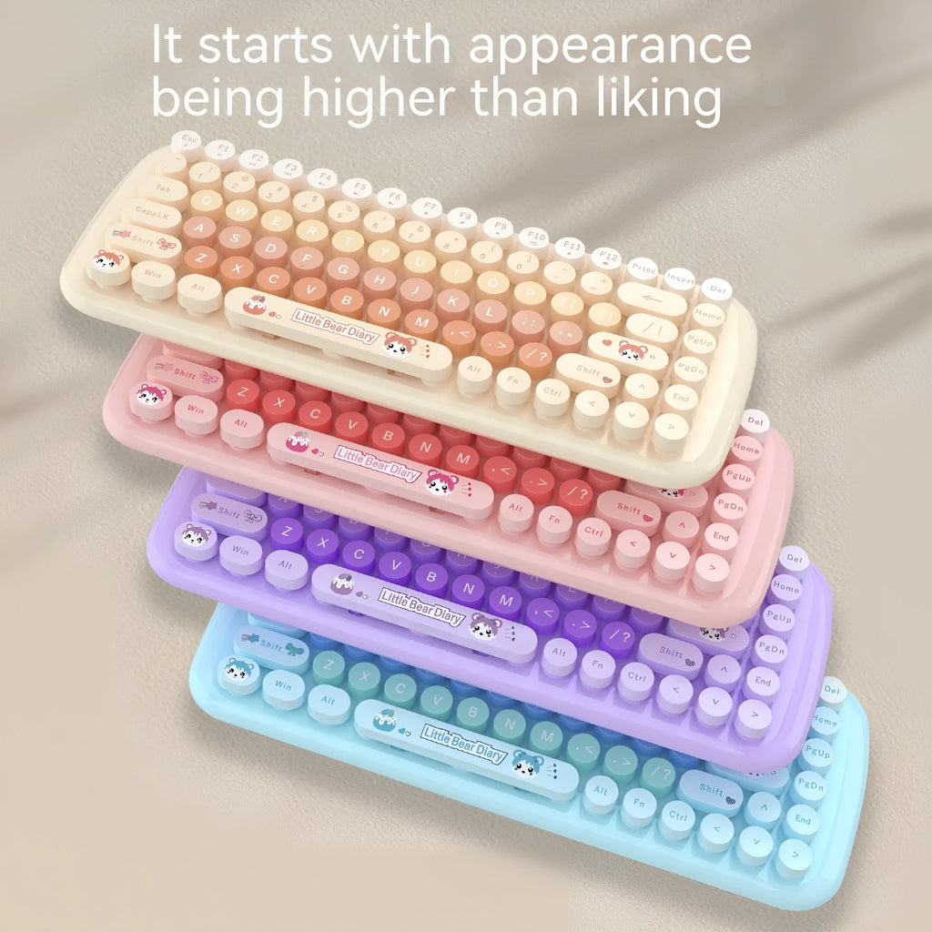 Pink mini wireless keyboard and mouse set with cute cartoon design on a desk.