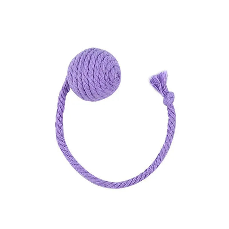 Green cat toy ball with attached rope and internal bell next to a pink one.