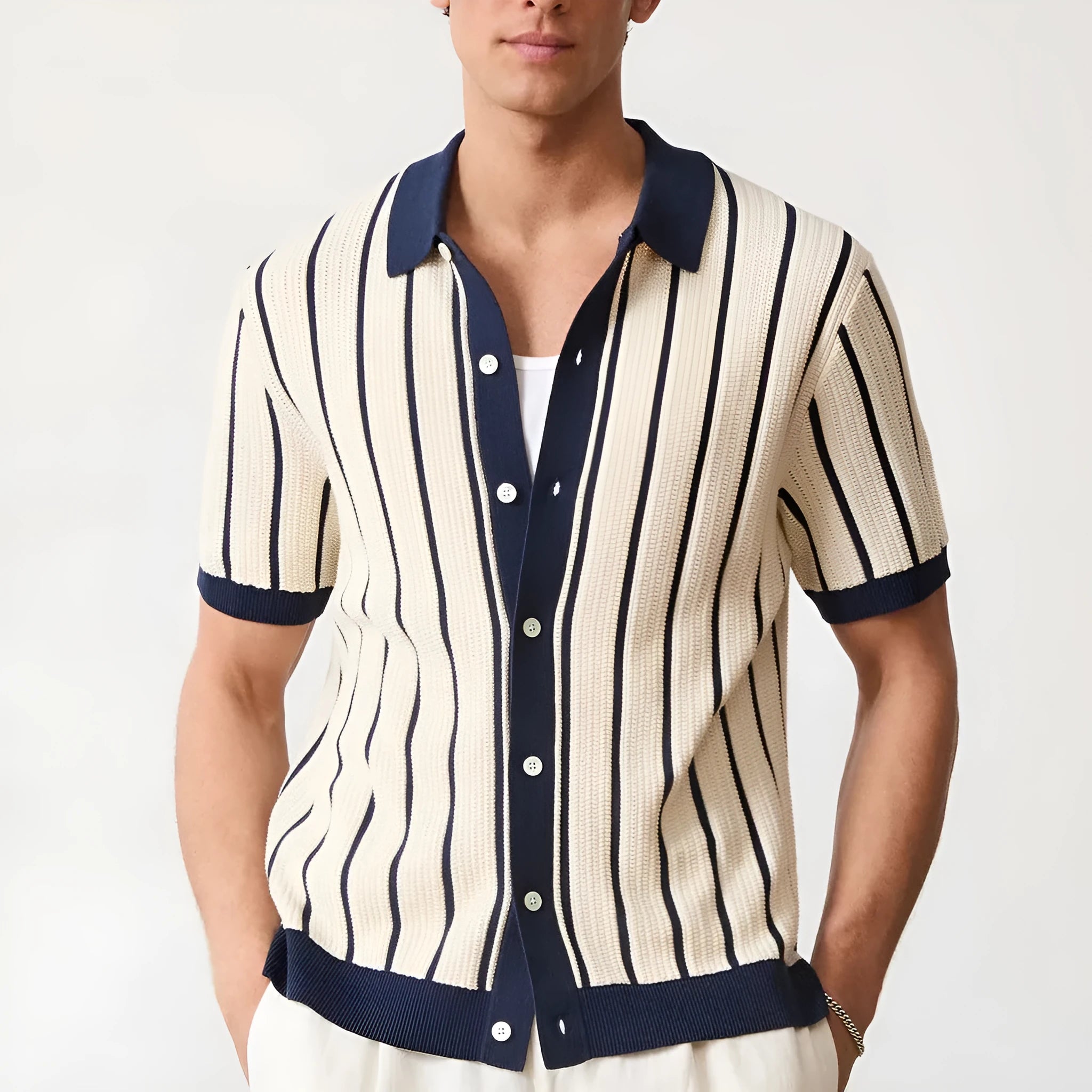 Men's white asymmetric short sleeve knitted top with a lapel collar on a model.